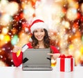 Woman with gift, laptop computer and credit card Royalty Free Stock Photo