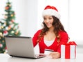 Woman with gift, laptop computer and credit card Royalty Free Stock Photo