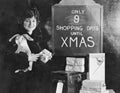 Woman with gifts and sign with number of shopping days until Christmas Royalty Free Stock Photo