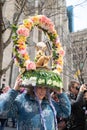 Woman in Gigantic floral hat with revolving bunny in Easter Bonnet Parade.