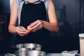 Woman girl baker in kitchen cooking whisk egg to bowl