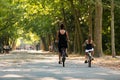 A woman and a girl biking in the Amsterdam Vondelpark