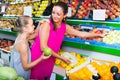 Woman with girl buying apples Royalty Free Stock Photo