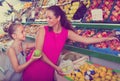 Woman with girl buying apples Royalty Free Stock Photo