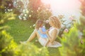 Woman with girl child at blossoming rose flowers Royalty Free Stock Photo