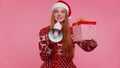 Woman girl in Christmas sweater with gift box scream in megaphone announces discounts sale shopping Royalty Free Stock Photo