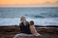 Woman with girl cuddling on seashore Royalty Free Stock Photo