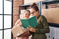 Woman and girl ecommerce business worker working with her daughter at office Royalty Free Stock Photo