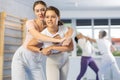 Woman and girl in gym perform basic elements of krav maga self-defense system.