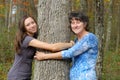 Woman and Girl Hugging Tree Royalty Free Stock Photo