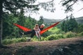 woman with girl kid on hammock mountains on background