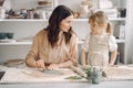 Portrait of mother and little girl shaping clay together Royalty Free Stock Photo