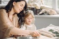 Portrait of mother and little girl shaping clay together Royalty Free Stock Photo