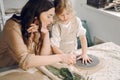 Portrait of mother and little girl shaping clay together Royalty Free Stock Photo