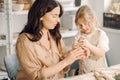 Portrait of mother and little girl shaping clay together Royalty Free Stock Photo