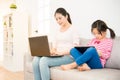 Woman and girl with laptop and digital tablet Royalty Free Stock Photo