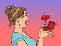 a woman girl looks at a red heart box valentine surprise greeting, love romance Royalty Free Stock Photo
