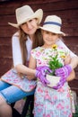 Woman and girl, mother and daughter, gardening together planting flowers in the garden. Looking at camera Royalty Free Stock Photo