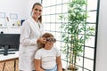 Woman and girl oculist and patient examining vision using optometrist glasses at clinic Royalty Free Stock Photo