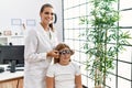 Woman and girl oculist and patient examining vision using optometrist glasses at clinic Royalty Free Stock Photo