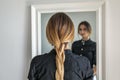 Woman girl with ombre hairstyle in braid in front of mirror