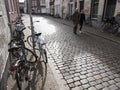 Woman and girl pass a lot of parked bicycles in the centre of old dutch city groningen