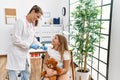 Woman and girl pediatrician and patient vaccinating at clinic Royalty Free Stock Photo