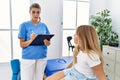 Woman and girl physiotherapist and patient having rehab session at physiotherapy clinic