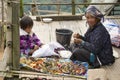 A woman and a girl produce traditional hill tribe souvenirs in Doi Ang Khang, Thailand.