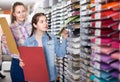 woman and girl shopping multicolored paper in art store