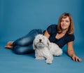 Woman girl sitting on the floor with a white dog