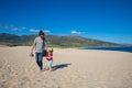 Woman and girl walking on sand of Valdevaqueros Beach in Cadiz