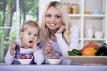 Woman and girl with yogurt bowl Royalty Free Stock Photo