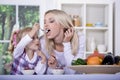 Woman and girl with yogurt bowl Royalty Free Stock Photo