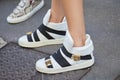 Woman with Giuseppe Zanotti white sneakers before Versace fashion show, Milan Fashion Week street style on June