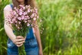 Woman give pink flowers as gift, with copy space as background