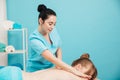 a woman is given a back massage treatment in the office Royalty Free Stock Photo