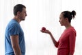 Woman gives apple to man Royalty Free Stock Photo