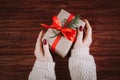 Woman gives beautiful gift box with red bow. Royalty Free Stock Photo