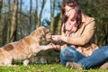 Woman gives dog a treat and gets the paw Royalty Free Stock Photo