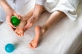 a woman gives a foot massage to a little girl with massage balls, baby massage, prevention of flat feet, osteopathy Royalty Free Stock Photo