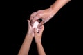 A woman gives her child a soap to protect against Coronavirus