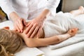 a woman gives a massage to a little girl, children& x27;s massage, prevention of scoliosis, osteopathy Royalty Free Stock Photo