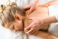 a woman gives a massage to a little girl, children& x27;s massage, prevention of scoliosis, osteopathy Royalty Free Stock Photo