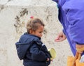 Woman gives money to cute beggar girl downtown of Skopje,capital of Macedonia