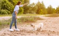 Woman giving a command to her obedient dog Royalty Free Stock Photo