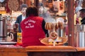 woman giving a cup of mulled wine at the christmas market