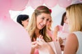 Woman giving gift to pregnant friend on baby shower