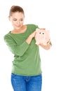 Woman giving her piggy bank a speculative look