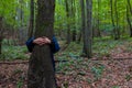 Woman giving a hug to the tree. World Environment Day concept photo Royalty Free Stock Photo